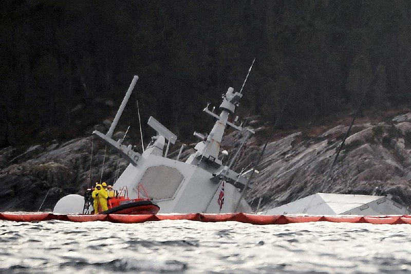 A crew approaches the partially submerged Norwegian frigate KNM Helge Ingstad, damaged in a collision last week, near Bergen, Norway, on Tuesday. 