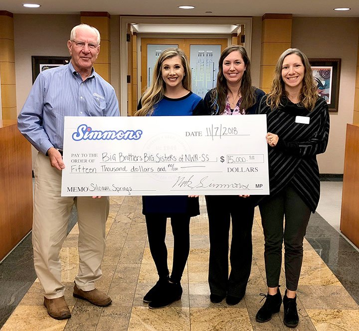 Photo submitted Simmons Foods recently made a generous contribution of $15,000 to the mentoring organization, Big Brothers Big Sisters of Siloam Springs. The company has committed to a three-year pledge of $5,000 per year totaling a $15,000 investment in the organization. Pictured, from left, are Mark Simmons, chairman of Simmons Foods; Amy Gober, executive director of Big Brothers Big Sisters Northwest Arkansas; Brooke Fowler, Big of the Year for Siloam Springs; and Tiffany Hansen, Siloam Springs program manager.