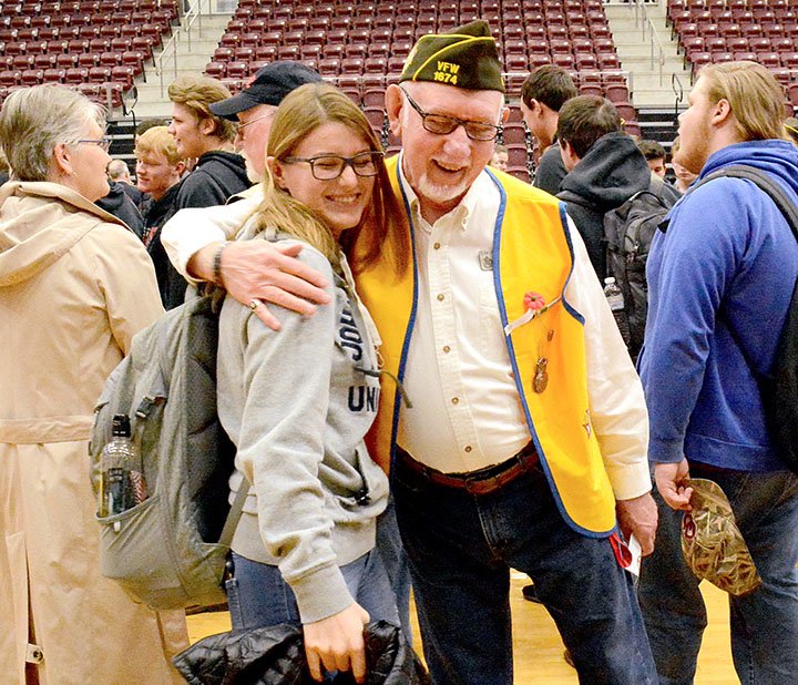 Janelle Jessen/Herald-Leader Student Nicole Bossler hugged Cecil Nichols, VFW Post 1674 member and high school social studies teacher, after the Veterans Day program at the Siloam Springs High School on Monday. Students were encouraged to greet the veterans after the program.