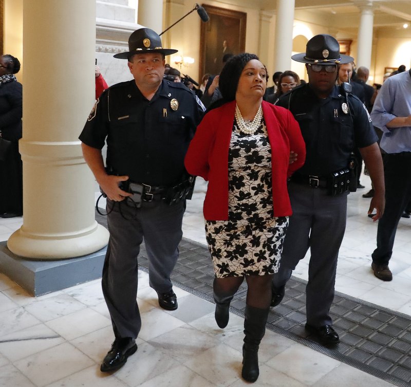 Sen. Nikema Williams (D-Atlanta) is arrested by capitol police during a protest over election ballot counts in the rotunda of the state capitol building Tuesday, Nov. 13, 2018, in Atlanta. (AP Photo/John Bazemore)