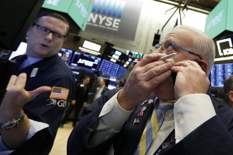 In this Friday, Nov. 9, 2018, file photo trader Thomas Ferrigno, right, and specialist Gregg Maloney work on the floor of the New York Stock Exchange. The U.S. stock market opens at 9:30 a.m. EDT on Tuesday, Nov. 13. (AP Photo/Richard Drew, File)