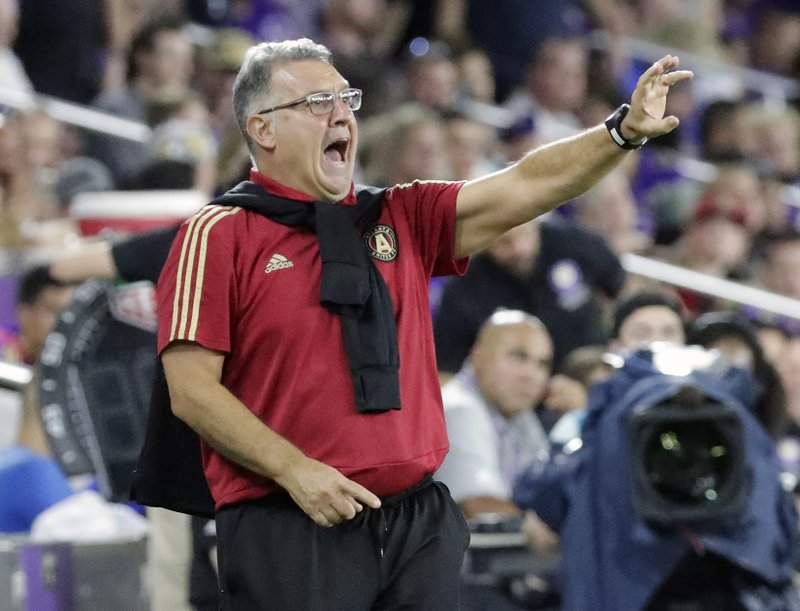 In this Aug. 24, 2018, file photo, Atlanta United MLS soccer team head coach Gerado "Tata" Martino directs his players during the second half of a match against Orlando City, in Orlando, Fla. Martino has been voted coach of the year in Major League Soccer. Martino won his first award after guiding Atlanta through another record-breaking season. (AP Photo/John Raoux, File)