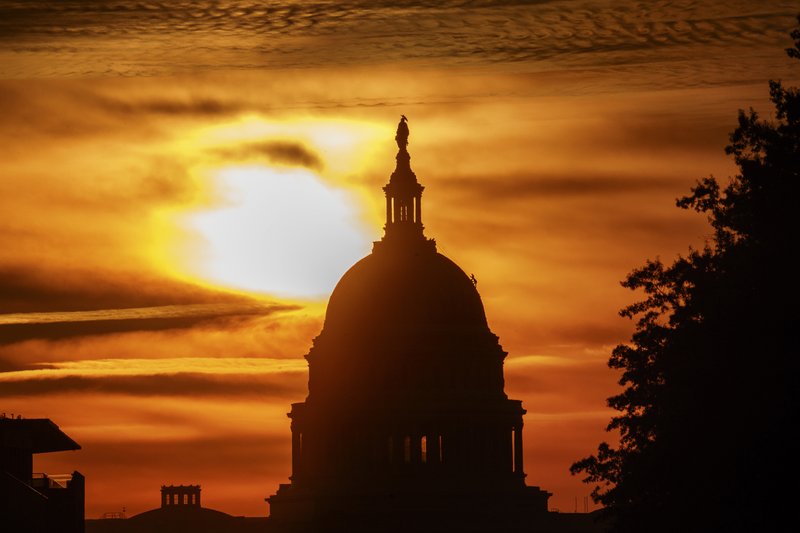 In this Oct. 26, 2018, file photo the rising sun silhouettes the U.S. Capitol dome at daybreak in Washington. The Treasury Department released a report Tuesday, Nov. 13, on how much money Uncle Sam took in and paid out last month. (AP Photo/Alex Brandon, File)