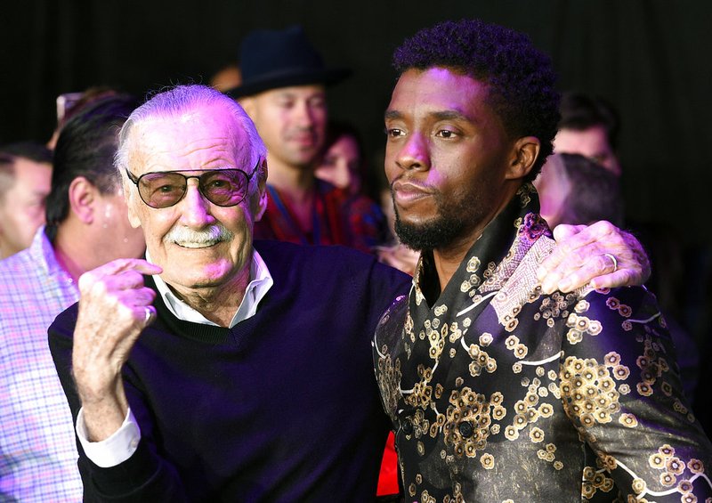 FILE - In this Monday, Jan. 29, 2018 file photo, comic book legend Stan Lee, left, creator of the "Black Panther" superhero, poses with Chadwick Boseman, star of the new "Black Panther" film, at the premiere at The Dolby Theatre in Los Angeles. Lee, the master and creator behind Marvel's biggest superheroes, died at age 95 Monday, Nov. 12, 2018 at a Los Angeles hospital. The works and ideas of Lee and the artists behind T'Challa, the Black Panther; Luke Cage, Hero for Hire; and Professor Xavier's band of merry mutants - groundbreaking during the 1960s and 1970s - have become a cultural force breaking down barriers to inclusion. (Photo by Chris Pizzello/Invision/AP, File)