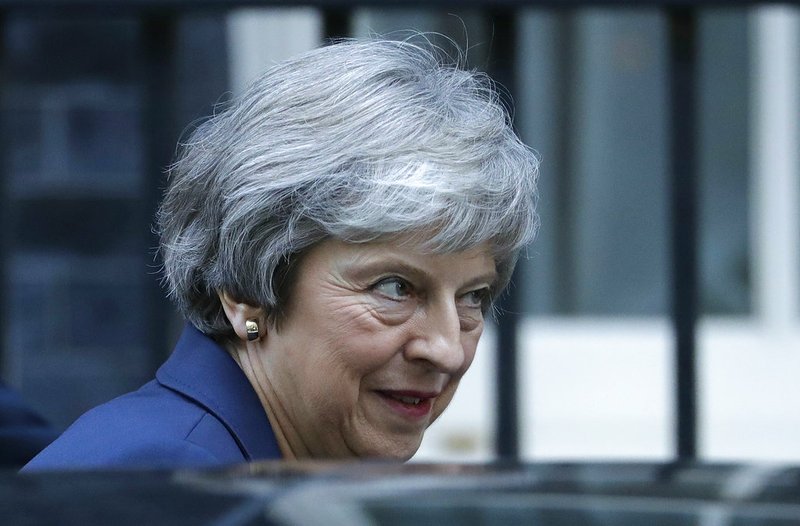 British Prime Minister Theresa May leaves 10 Downing Street heading to Parliament for Prime Minister's questions in London, Wednesday, Nov. 14, 2018. May will try to persuade her divided Cabinet on Wednesday that they have a choice between backing a draft Brexit deal with the European Union or plunging the U.K. into political and economic uncertainty. (AP Photo/Matt Dunham)