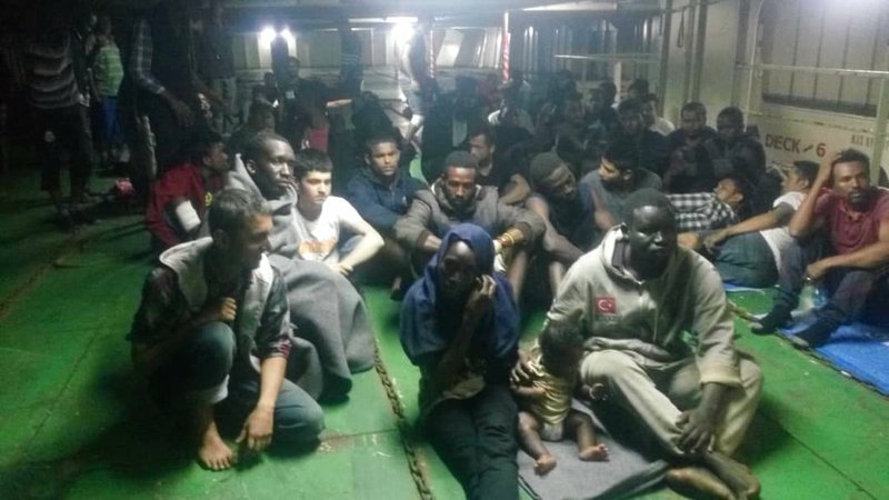 In this photo provided Nov. 14, 2018, migrants on board the container ship Nivin are refusing to disembark in Misrata, Libya. A total of 91 migrants, including a baby, were rescued by the ship's crew last weekend after leaving Libya in a raft. (AP Photo)