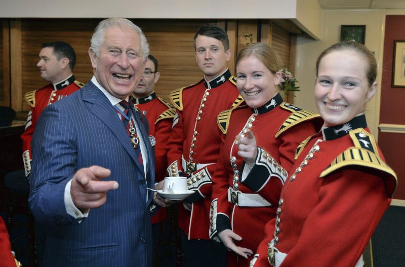 Prince Charles The Prince of Wales, Colonel Welsh Guards, shares a light moment with members of the Welsh Guards band at a remembrance service at the Guards' Chapel, Wellington Barracks in London, Sunday Nov. 11, 2018.  