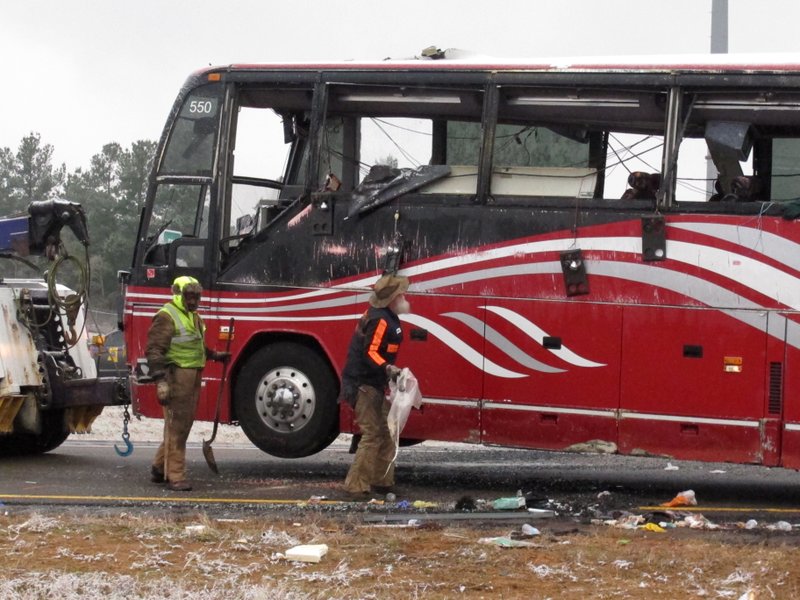 Debris litters the scene where a tour bus carrying passengers overturned just after midday, Wednesday, Nov. 14, 2018, in DeSoto County, Miss. The crash came as a winter storm has been raking parts of the South. (Joe Rondone/The Commercial Appeal via AP)