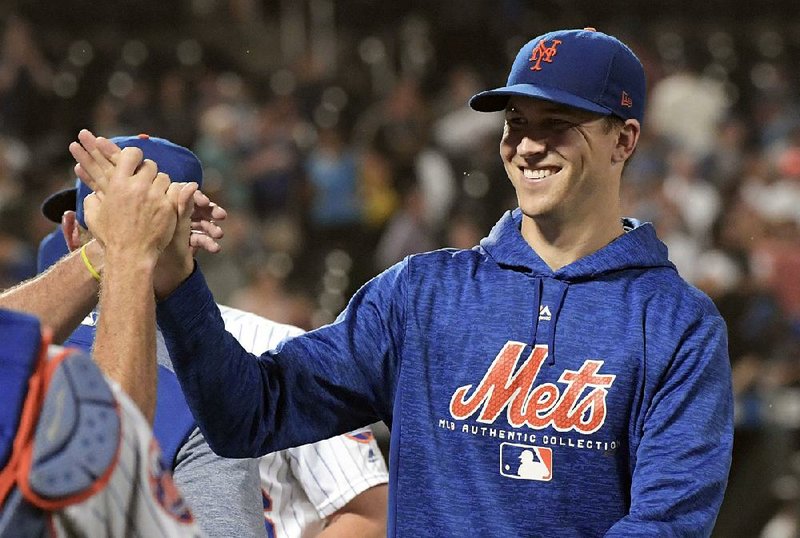  In this Sept. 26, 2018, file photo, New York Mets pitcher Jacob deGrom smiles after getting the win as the Mets defeated the Atlanta Braves 3-0 in a baseball game in New York. DeGrom won the National League Cy Young Award on Wednesday, Nov. 14. 