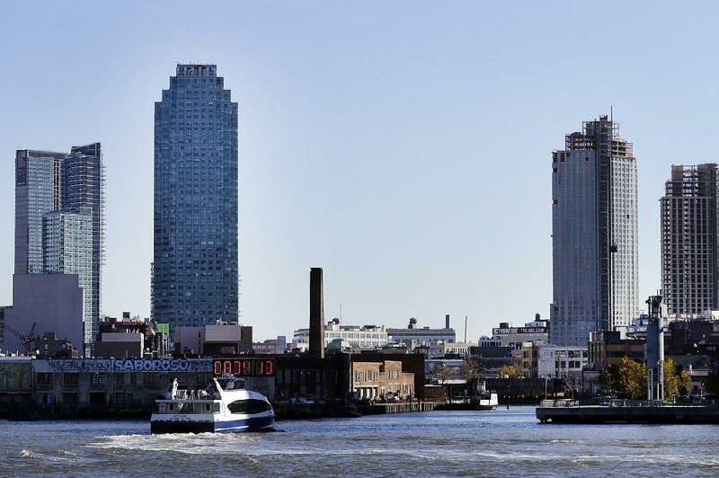 A water taxi approaches the Long Island City waterfront and skyline, in the Queens borough of New York near where an Amazon corporate complex will be built. 