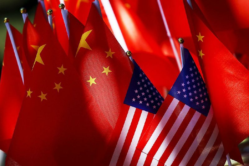 American flags are displayed with Chinese flags on top of a trishaw in Beijing in September. A congressional commission said Wednesday that government purchases of Chinese-made Internetlinked devices can expose the U.S. to security breaches. 