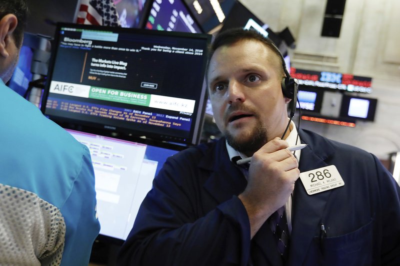 Trader Michael Milano works on the floor of the New York Stock Exchange, Wednesday, Nov. 14, 2018. Energy companies led U.S. stocks broadly higher in early trading Wednesday, wiping out some of the market's losses from a day earlier. (AP Photo/Richard Drew)