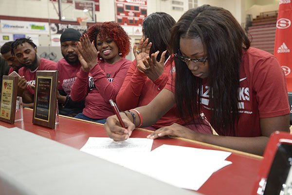 Springdale guard Marquesha Davis (right) signs a National Letter of Intent Wednesday, Nov. 14, 2018, to play basketball for Arkansas during a signing ceremony inside Bulldog Arena in Springdale.