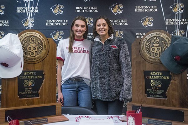Lainey Quandt (left) and Tori Willis, Bentonville cross country runners, pose for a photo after signing to run at Arkansas on Wednesday, Nov. 14, 2018, during a signing ceremony at Bentonville's Tiger Athletic Complex. 