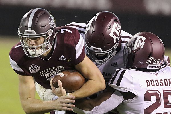 Mississippi State quarterback Nick Fitzgerald (7) is tackled by Texas A&M defensive lineman Jayden Peevy, center and Tyrel Dodson (25) during the first half of their NCAA college football game on Saturday, Oct. 27, 2018, in Starkville, Miss. (AP Photo/Jim Lytle)

