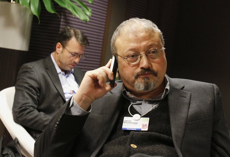FILE - In this Jan. 29, 2011 file photo, Saudi journalist Jamal Khashoggi speaks on his cellphone at the World Economic Forum in Davos, Switzerland. (AP Photo/Virginia Mayo, File)

