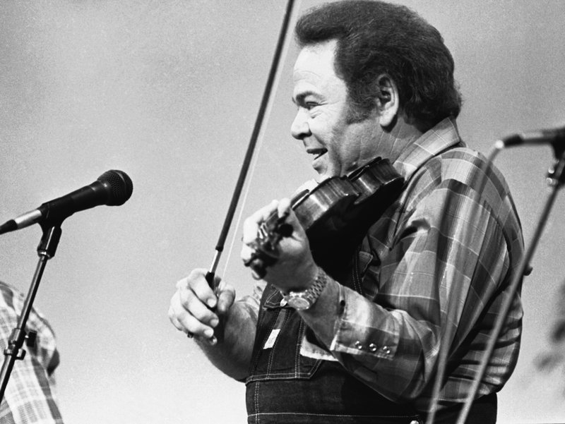 FILE - In this June 27, 1983, file photo, entertainer Roy Clark plays the fiddle during a taping of the syndicated television show "Hee Haw," in Nashville, Tenn. Clark, the guitar virtuoso and singer who headlined the cornpone TV show "Hee Haw" for nearly a quarter century, died Thursday, Nov. 15, 2018, due to complications from pneumonia at home in Tulsa, Okla., publicist Jeremy Westby said. He was 85. (AP Photo/Mark Humphrey, File)
