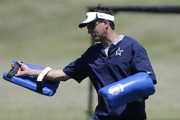 Derek Dooley, an assistant for the Dallas Cowboys instructs players during an NFL football minicamp on Tuesday, June 11, 2013, in Irving, Texas. (AP Photo/Tony Gutierrez)

