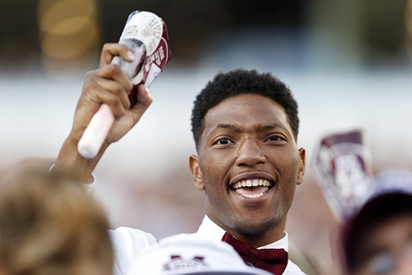 A Mississippi State fan celebrates by ringing a cowbell during the second half of an NCAA college football game against Alabama in Starkville, Miss., Saturday, Nov. 14, 2015. (AP Photo/Rogelio V. Solis)

