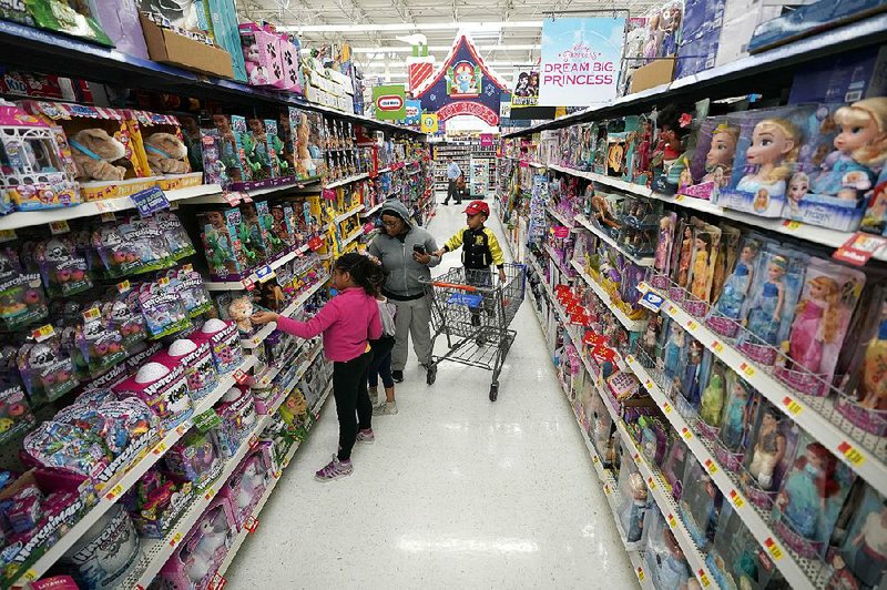 FILE — Shoppers look at the toys at a Walmart Supercenter in Houston in November 2018. 