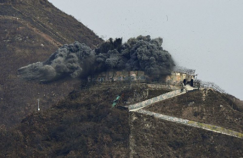 Dynamite explodes Thursday as South Korea’s military demolishes a guard post at Cheorwon in the Demilitarized Zone on the border with North Korea. 
