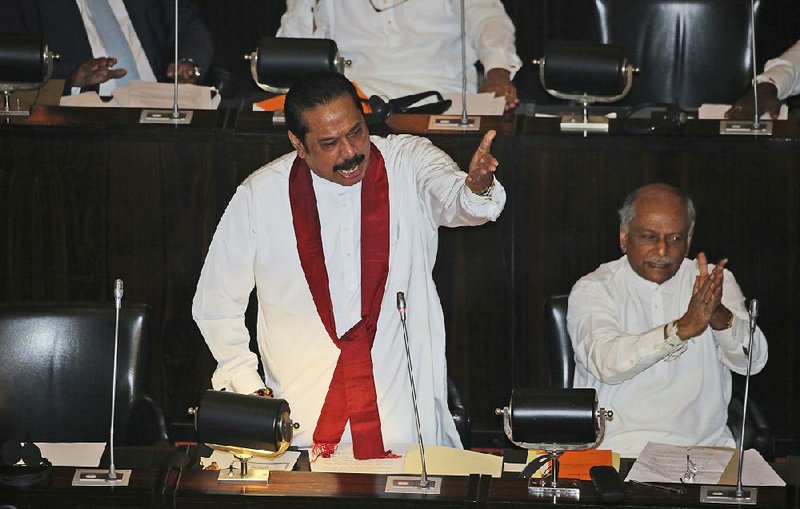 Sri Lanka’s disputed Prime Minister Mahinda Rajapaksa speaks at the parliament chamber in Colombo on Thursday. 