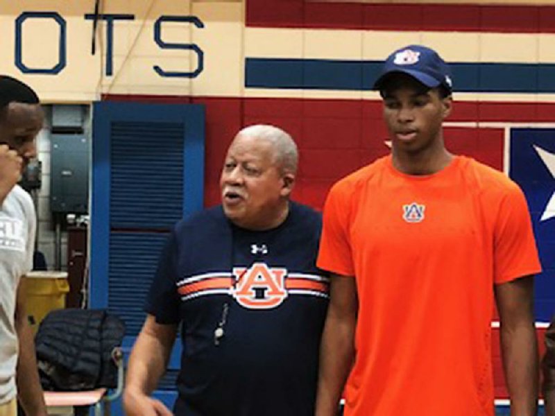 Little Rock Parkview Coach Al Flanigan and grandson Allen Flanigan talk with friends and family during Allen Flanigan’s signing ceremony with Auburn.