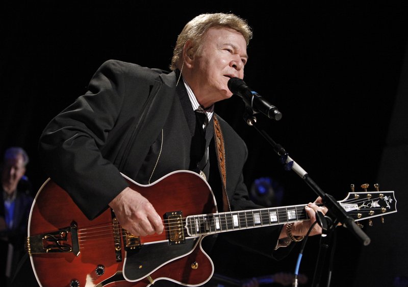 FILE - In this May 17, 2009, file photo, country music star Roy Clark performs after being inducted into the Country Music Hall of Fame in Nashville, Tenn. Clark, the guitar virtuoso and singer who headlined the cornpone TV show &quot;Hee Haw&quot; for nearly a quarter century, died Thursday, Nov. 15, 2018, due to complications from pneumonia at home in Tulsa, Okla., publicist Jeremy Westby said. He was 85. (AP Photo/Mark Humphrey, File)