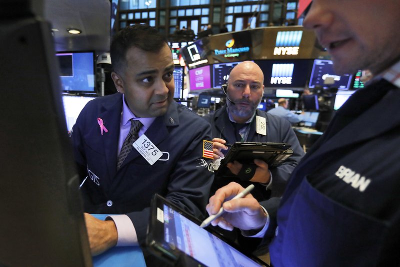 FILE- In this Thursday, Nov. 8, 2018, file photo, specialist Dilip Patel, left, works at his post on the floor of the New York Stock Exchange. The U.S. stock market opens at 9:30 a.m. EDT on Thursday, Nov. 15. (AP Photo/Richard Drew, File)