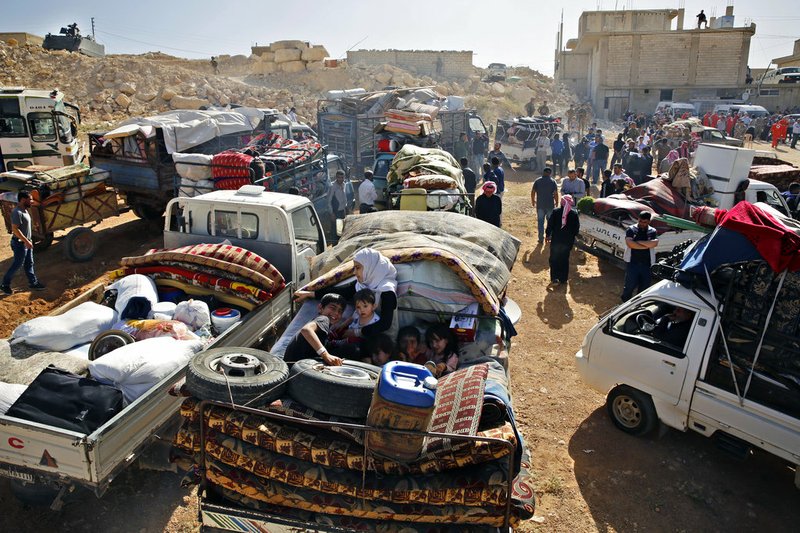 This Thursday, June 28, 2018, file photo, Syrian refugees gather in their vehicles getting ready to cross into Syria from the eastern Lebanese border town of Arsal, Lebanon. The Russian military said Friday, Nov. 16, 2018 that nearly 270,000 Syrian refugees have returned home from exile in recent months, including 6,000 in the last week alone. (AP Photo/Bilal Hussein, File)