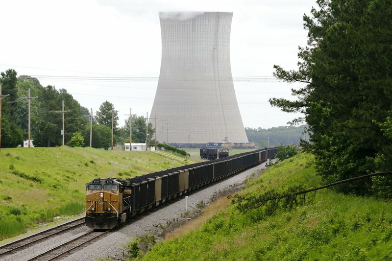 In June 2, 2014 file photo, a coal train stops near White Bluff power plant near Redfield, Ark. Entergy Arkansas says it will eventually stop using coal at two power plants and shut down a natural gas plant under a settlement reached with environmental groups. Entergy says it will stop using coal no later than the end of 2028 at its White Bluff plant and by the end of 2030 at its Independence plant. (AP Photo/Danny Johnston File)