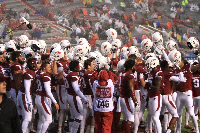 FILE — The Hogs prepare to go on the the field during a rainy night at War Memorial Stadium in 2018.