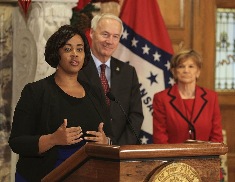 Keesa Smith (left), Department of Human Services deputy director, is shown in this file photo with Gov. Asa Hutchinson and Youth Services Division Director Betty Guhman. 