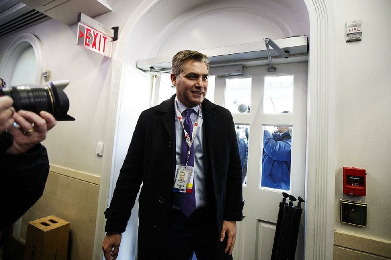 Jim Acosta of CNN arrives at the White House on Friday, press pass dangling. 