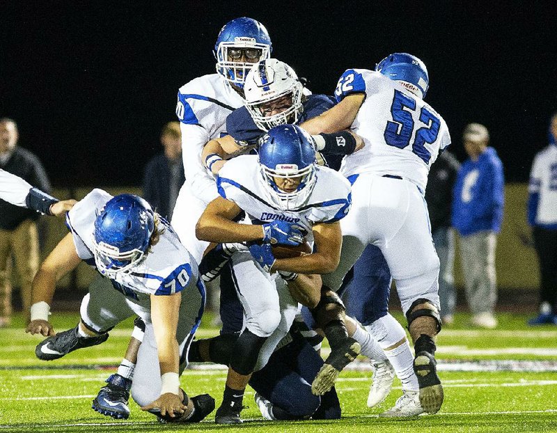 Conway’s Cary McClain (center) tries to gain yards against Bentonville West on Friday at Wolverine Stadium in Centerton. Bentonville West won 31-17 to advance to a semifinal at North Little Rock. 