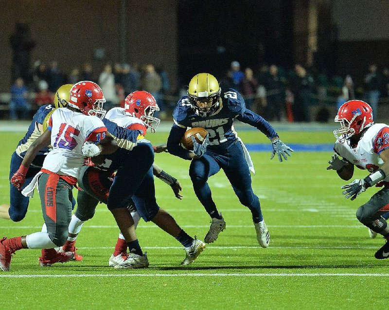 Pulaski Academy running back Jayden Kelley (21) runs through a hole in the Little Rock McClellan defense Friday during the Bruins’ 58-8 victory over the Lions. 