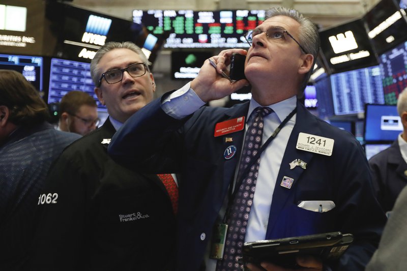 In this Nov. 8, 2018, file photo traders Eric Schumacher, left, and Richard Deviccaro work on the floor of the New York Stock Exchange.  (AP Photo/Richard Drew, File)