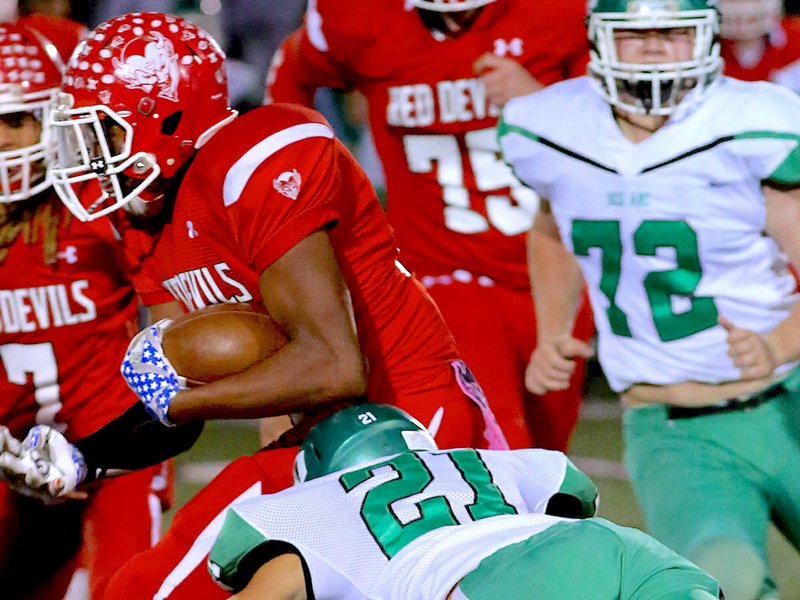 Special to The Sentinel-Record/Corbet Deary RUN OUT: Des Arc linebacker Zeke Tacker (21) goes for a tackle against Mountain Pine ball carrier Elijah Browning Friday as the Eagles ousted the Red Devils from the Class 2A playoffs, 49-25, at Fountain Lake's Allen Tillery Field.