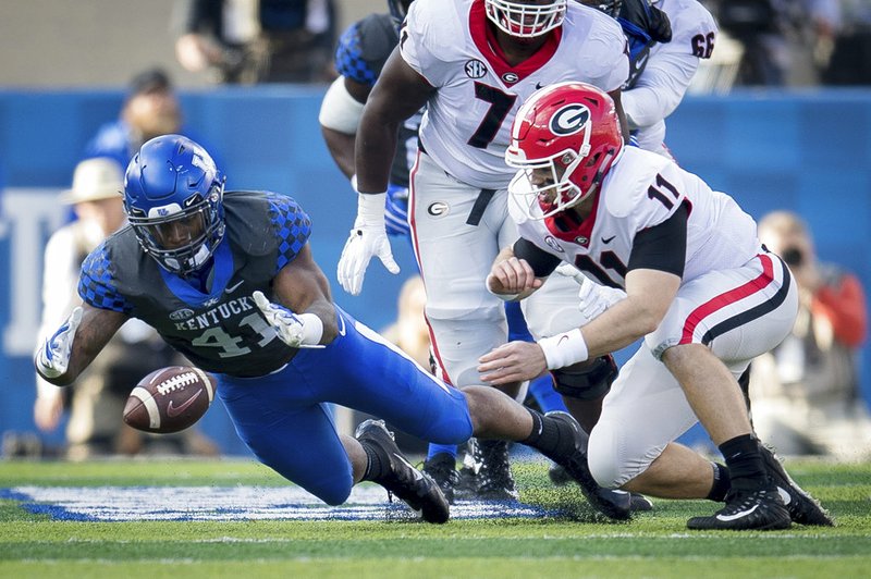 Kentucky linebacker Josh Allen (41) dives on the fumble of Georgia quarterback Jake Fromm (11) during the first half an NCAA college football game in Lexington, Ky., Saturday, Nov. 3, 2018. (AP Photo/Bryan Woolston)