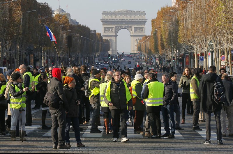Protesters blocs the Champs Elysees avenue to protest fuel taxes in Paris, France, Saturday, Nov. 17, 2018. France is bracing for a nationwide traffic mess as drivers plan to block roads to protest rising fuel taxes, in a new challenge to embattled President Emmanuel Macron. (AP Photo/Michel Euler)