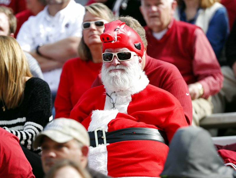 A "Santa Hog" watches Arkansas play Mississippi State during the first half of an NCAA college football game in Starkville, Miss., Saturday, Nov. 17, 2018. (AP Photo/Rogelio V. Solis)