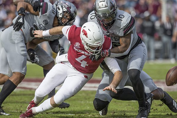 Mississippi State linebacker Leo Lewis (10) forces Arkansas quarterback Ty Storey to fumble during the second quarter Saturday, Nov. 17, 2018, at Davis Wade Stadium in Starkville, Miss. The ball was recovered first by Mississippi State, then fumbled again with Arkansas recovering for a first down.
