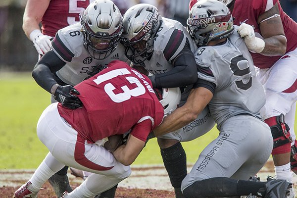 Arkansas quarterback Connor Noland is sacked by Mississippi State defenders Willie Gay Jr., Erroll Thompson and Montez Sweat during a game Saturday, Nov. 17, 2018, in Starkville, Miss. 