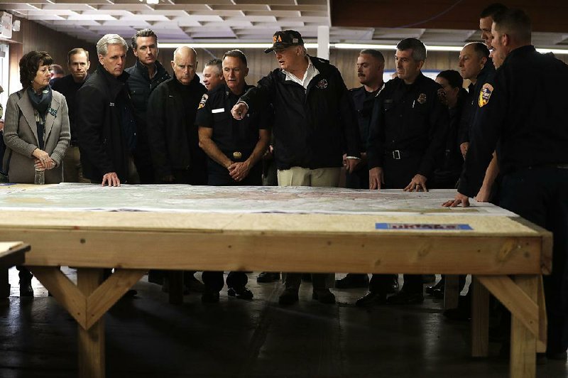 President Donald Trump gets a look at a wildfires map Saturday at an operations center in Chico, Calif. With the president are (from left) Paradise, Calif., Mayor Jody Jones, House Majority Leader Kevin McCarthy, California Gov.-elect Gavin Newsom, Gov. Jerry Brown and several first responders. 