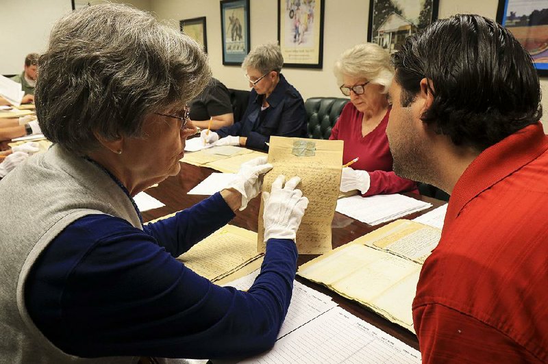 Volunteer Lynda Suffridge (left) and Archival Assistant Josh Couch work Tuesday morning at the Arkansas State Archives going through old court records from Hempstead County. 
