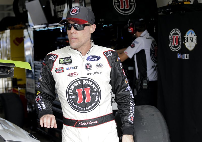 Kevin Harvick stands in the garage during qualifying for the NASCAR Cup Series auto race at the Homestead-Miami Speedway, Saturday, Nov. 17, 2018, in Homestead, Fla. (AP Photo/Terry Renna)