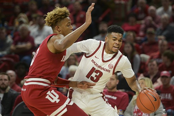 Arkansas guard Mason Jones (13) dribbles past Indiana guard Romeo Langford (0) during a basketball game Sunday, Nov. 18, 2018, at Bud Walton Arena in Fayetteville.