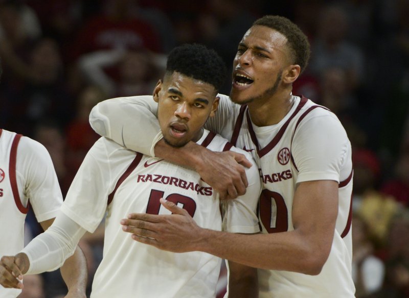 Arkansas Razorbacks forward Daniel Gafford (10) embraces guard Mason Jones (13) during a basketball game, Sunday, November 18, 2018 at Bud Walton Arena in Fayetteville.

