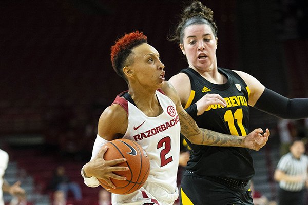 Arkansas guard Alexis Tolefree drives to the basket as Arizona State's Robbi Ryan defends at Bud Walton Arena on Sunday, Nov. 18, 2018, in Fayetteville. 