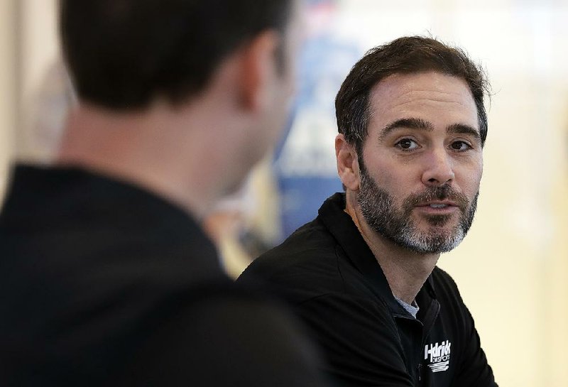 NASCAR driver Jimmie Johnson, right, speaks to the media as crew chief Chad Knaus, left, listens during a news conference in Charlotte, N.C., Thursday, Oct. 11, 2018. 